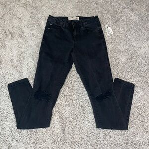Garage black high waisted skinny jean with rips in the knees. Size USA 1